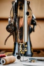 Steel needle with looper and a presser foot of old vintage hand sewing machine close-up Royalty Free Stock Photo