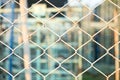 Steel net fence with blur background Royalty Free Stock Photo