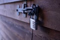 Steel padlock on dark wooden shed Royalty Free Stock Photo