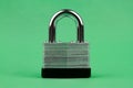 Steel Padlock on Green Background