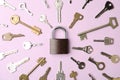 Steel padlock and keys on pink background. Safety concept