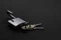 Steel padlock with three keys on black surface Royalty Free Stock Photo