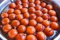 Pan full of syrup laden Gulab Jamuns