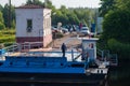 Moscow region, Russia, July 3, 2023. Cars are waiting for the ferry at the river pier.