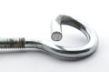 Steel pigtail screw hook on white background.