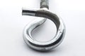 Steel pigtail screw hook on white background