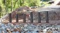 Steel pilings sit in front of rip rap on a bridge project