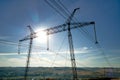 Steel pillar with high voltage electric power lines delivering electrical energy through cable wires on long distance Royalty Free Stock Photo