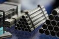 Steel pipes against industrial blurred background, close-up Royalty Free Stock Photo