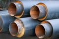 Steel pipes with thermal insulation in the shell of a plastic pipe at a construction site, closeup.