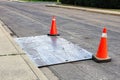 A steel plate on the road with construction pylons Royalty Free Stock Photo