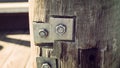 Steel plates and bolts on a wooden pier support Royalty Free Stock Photo