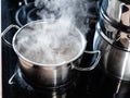 steel pot of boiling water on stove at home Royalty Free Stock Photo