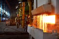 Steel quenching at high temperature in industrial furnace at the workshop of a forge plant. Royalty Free Stock Photo