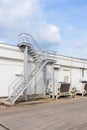 Steel railing roof stairs. Metal staircase to the roof of a modern building. Stairwell fire or emergency exit on wall of building Royalty Free Stock Photo