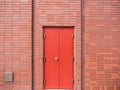 Steel Red Door on Red Brick Wall Royalty Free Stock Photo