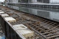 Steel reinforcing tie wire work at construction site of embankment for canal path and protecting riverbank collapse structures.