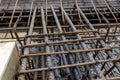 Steel reinforcing tie wire work at construction site of embankment for canal path and protecting riverbank collapse structures.