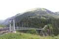 Steel rope suspenion bridge spanning the gorge in a mountain landscape Royalty Free Stock Photo