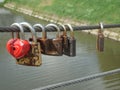 Lock red heart and old rusty locks on the bridge Royalty Free Stock Photo