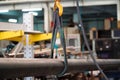 Steel round bar with lifting belt in steel warehouse,Yellow hook with belt on steel plant background