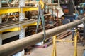 Steel round bar with lifting belt in steel warehouse,Yellow hook with belt on steel plant background