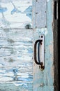 Steel rusty doorhandle on very old wooden door with cracked and Royalty Free Stock Photo