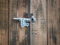 Steel rusty metal latch lock hanging outdoors on wooden double door Royalty Free Stock Photo