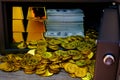 Steel safes box full of coins stack and gold bar and banknote 100 USD