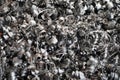 Steel scrap materials recycling. Aluminum chip waste after machining metal parts on a cnc lathe. Closeup twisted spiral steel