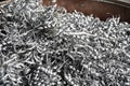 Steel scrap materials recycling. Aluminum chip waste after machining metal parts on a cnc lathe. Closeup twisted spiral steel