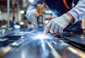 Close up of a technician performing precision welding with sparks flying in a modern manufacturing facility Royalty Free Stock Photo