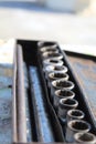 A steel socket tool in a rusty box