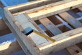 Steel square tool is on timber logs, construction site