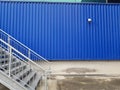 Steel stair and Blue wall texture warehouse