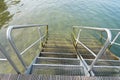 Steel stairs with railings for waterfront access.