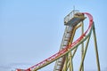 Steel structure of the highest point of a green and blue painted rollercoaster track showing the ascending and descenting parts Royalty Free Stock Photo