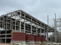 Steel structure of new industrial building under cloud blue sky. New technology structural frame beam of factory in construction. Royalty Free Stock Photo