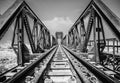 Steel structure of railway bridge, railway rail with vanishing point Royalty Free Stock Photo