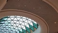 Steel structure roof ceiling made of metal and glass with blue sky background. Modern sleek shopping architecture in mall Royalty Free Stock Photo