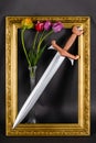 Steel sword with bronze hilt and tulip flowers in gold frame