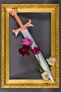 Steel sword with bronze hilt and tulip flowers in gold frame