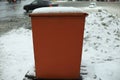 Steel tank. Dumpster. Place to store sand on highway. Orange object in winter on road