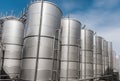 Steel tanks for wine fermentation at a modern winery. Large brewery silos for barley or beer Royalty Free Stock Photo