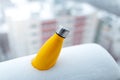 Steel thermo bottle of yellow color in snow. Close-up view. Reusable thermos