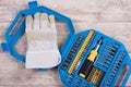 steel toolset and working glove on a wooden table and working glove on a wooden table