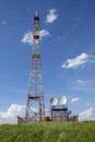 Steel tower of digital TV, cellular mobile communication repeater on the hill Royalty Free Stock Photo