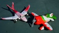 Steel toy aircraft models from Disney Pixar Planes movie, El Chupacabra and Rochelle, standing on plastic surface as on airfield