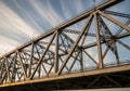 Steel truss bridge with intricate triangular patterns, supported by robust pillars. The Royalty Free Stock Photo
