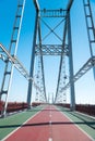 Steel urban bridge running between river banks Royalty Free Stock Photo